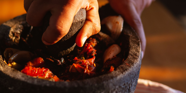 Hand-grinding spices in a traditional mortar